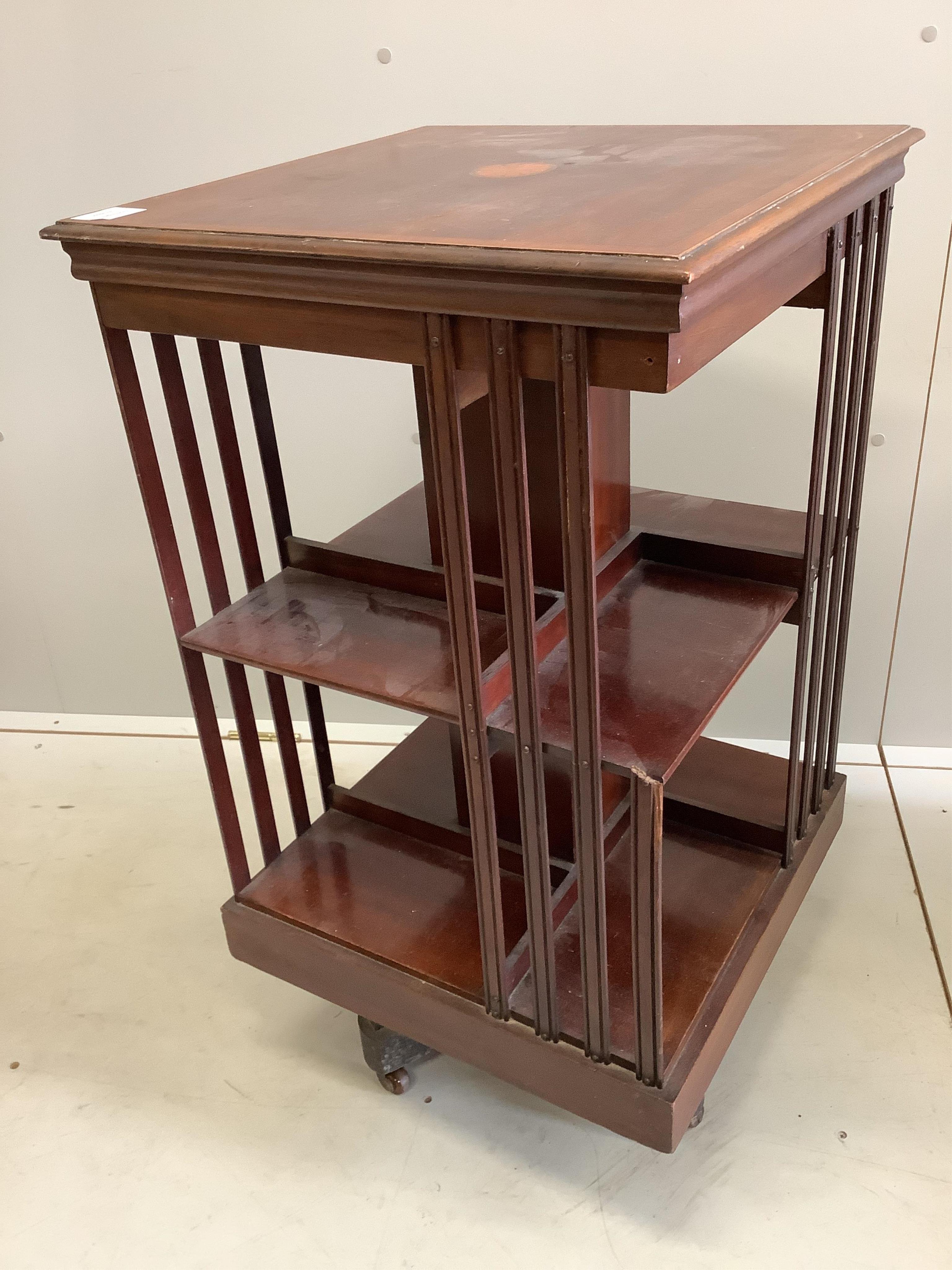 An Edwardian inlaid mahogany revolving bookcase, width 47cm, depth 47cm, height 84cm. Condition - poor